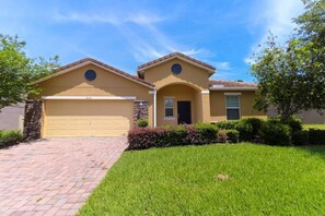 Stunning two-story home with a garage and beautifully manicured lawn.