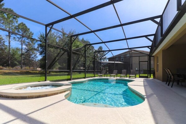 Relax by the pool surrounded by a deck and lounge chairs.