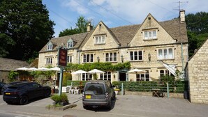 A stone building with a sign reading "The Old Place." - The Coach House and The Stable (Stroud)