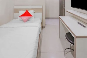 Cozy retreat with a single bed, desk area, and TV for a comfortable stay.