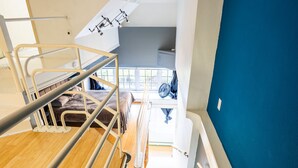 A modern interior with a staircase leading to a loft bedroom. - Downtown City Condo (Tacoma)
