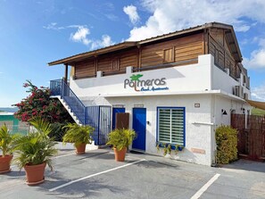A two-story building with a sign reading "Pomeras Beach Apartments". - Ocean View Apt with Jacuzzi and Terrance in Playa Santa (Guanica)