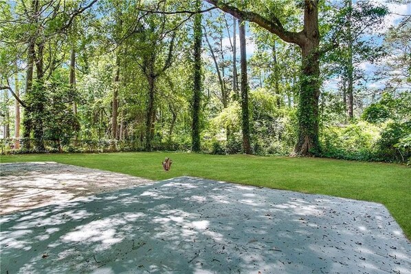 Stroll through the serene grounds, surrounded by lush trees and a well-manicured lawn.