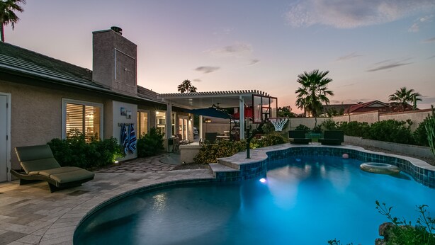 A residential backyard with a swimming pool, patio furniture, and a covered outdoor area. - Spectacular Hillside Fountain HIlls home + Resort Backyard and Views! (Fountain Hills)