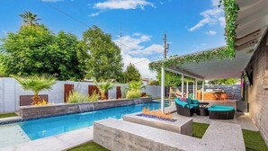 A backyard with a swimming pool, outdoor seating, and a pergola with climbing plants. - Love Oasis II - Scottsdale Beach Club NEW (Scottsdale)