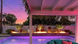 An outdoor pool area with a fire feature and a covered seating area. - Love Oasis II - Scottsdale Beach Club NEW (Scottsdale)