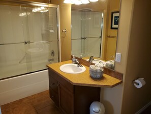 Combined shower/bathtub, towels, soap, toilet paper