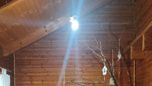 A wooden cabin with a hot tub labeled "AREBOS Florence" and a branch with hanging decorations. - villa chalet con piscina (Palermo)