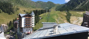 Panorama of Foppolo, the mountains and the slopes in the morning sun