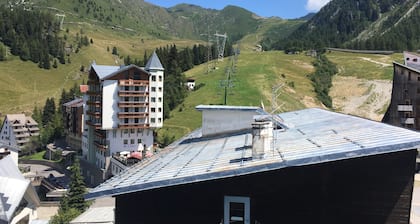 Panorama of Foppolo, the mountains and the slopes in the morning sun