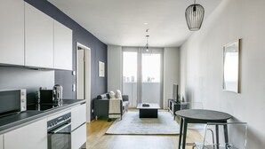 A modern apartment with a kitchen, dining area, and living space.