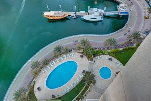 Relax by the infinity pool overlooking the marina and water.