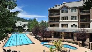 A hotel with a swimming pool, outdoor seating, and a view of the mountains. - Ski-In & Out Your Doorstep! Lovely Interior, Pool/Hot Tub! (Beaver Creek)