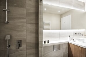 A modern bathroom with a shower, a sink, and a mirror. - Charitos II Chic n modern 2BD Apt (Athens)