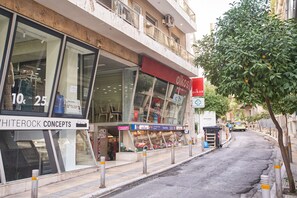 A storefront with a sign for 'oiKOS' and 'WHITEROCK CONCEPTS'.