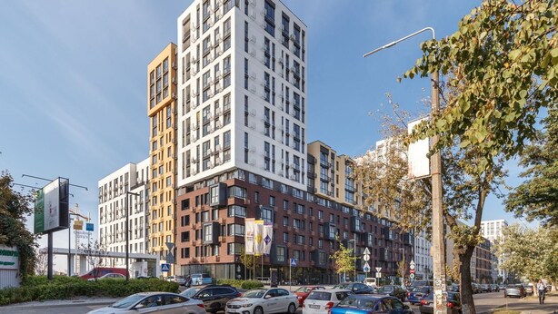 A multi-story building with a modern architectural design, featuring a mix of white and brown facades. - Kiev Hostel (Kyiv)