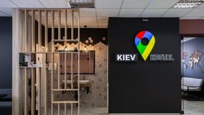 A reception area with a wooden partition, a sink, and a wall-mounted map. - Kiev Hostel (Kyiv)