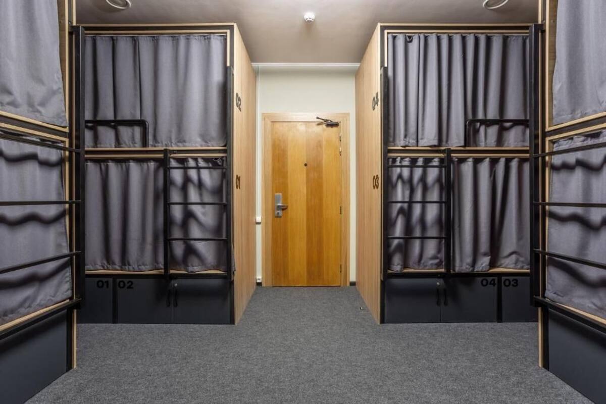 A corridor with bunk beds, each labeled with a number.