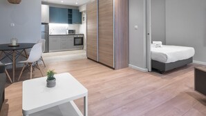 A modern apartment with a dining area, a small kitchen, a bedroom, and a living room. - New Yorker Nilie Hospitality MGMT (Thessaloniki)