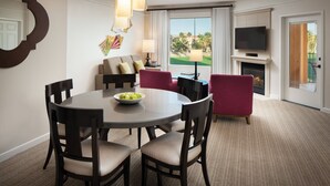 A hotel room with a dining area, a sofa, a fireplace, and a TV. - Marriott Shadow Ridge I, X-Large One bedroom Villa with Fireplace, Kitchen, W/D (Palm Desert)