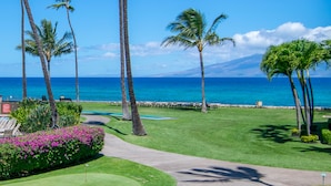 A golf course with a view of the ocean and a mountain in the distance. - Spacious 3bd Papakea condo, the perfect getaway (Lahaina)