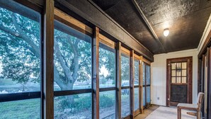A room with large windows, a wooden bench, and a door. - Country Living at its Best! (Roanoke)