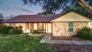 A stone house with a tiled roof, a front porch, and a landscaped yard. - Country Living at its Best! (Roanoke)
