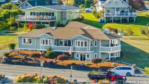 A large, two-story house with a prominent front porch and a garage. - Gig Harbor Downtown Waterfront Retreat (Gig Harbor)