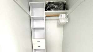 A small walk-in closet with a wooden floor, white walls, and a white shelving unit with drawers. - Newly Renovated Private Master Suite-10MIN to Golden Gate Park. (San Francisco)