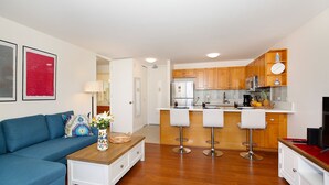 A modern apartment with a living room, kitchen, and dining area.