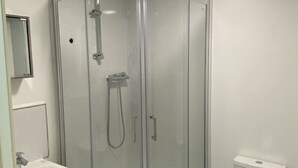 A modern bathroom with a glass-enclosed shower, a white sink, and a toilet. - Inviting 3-bed Apartment in Stockton-on-tees (Stockton-on-Tees)