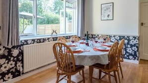 A dining room with a table set for six, large windows, and a radiator. - The Spinney, Saxtead near Framlingham (Woodbridge)