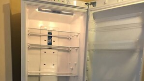 An open refrigerator with multiple shelves and drawers, including a water and air freshener compartment. - Impeccable 3-bed Apartment in Stockton-on-tees (Stockton-on-Tees)