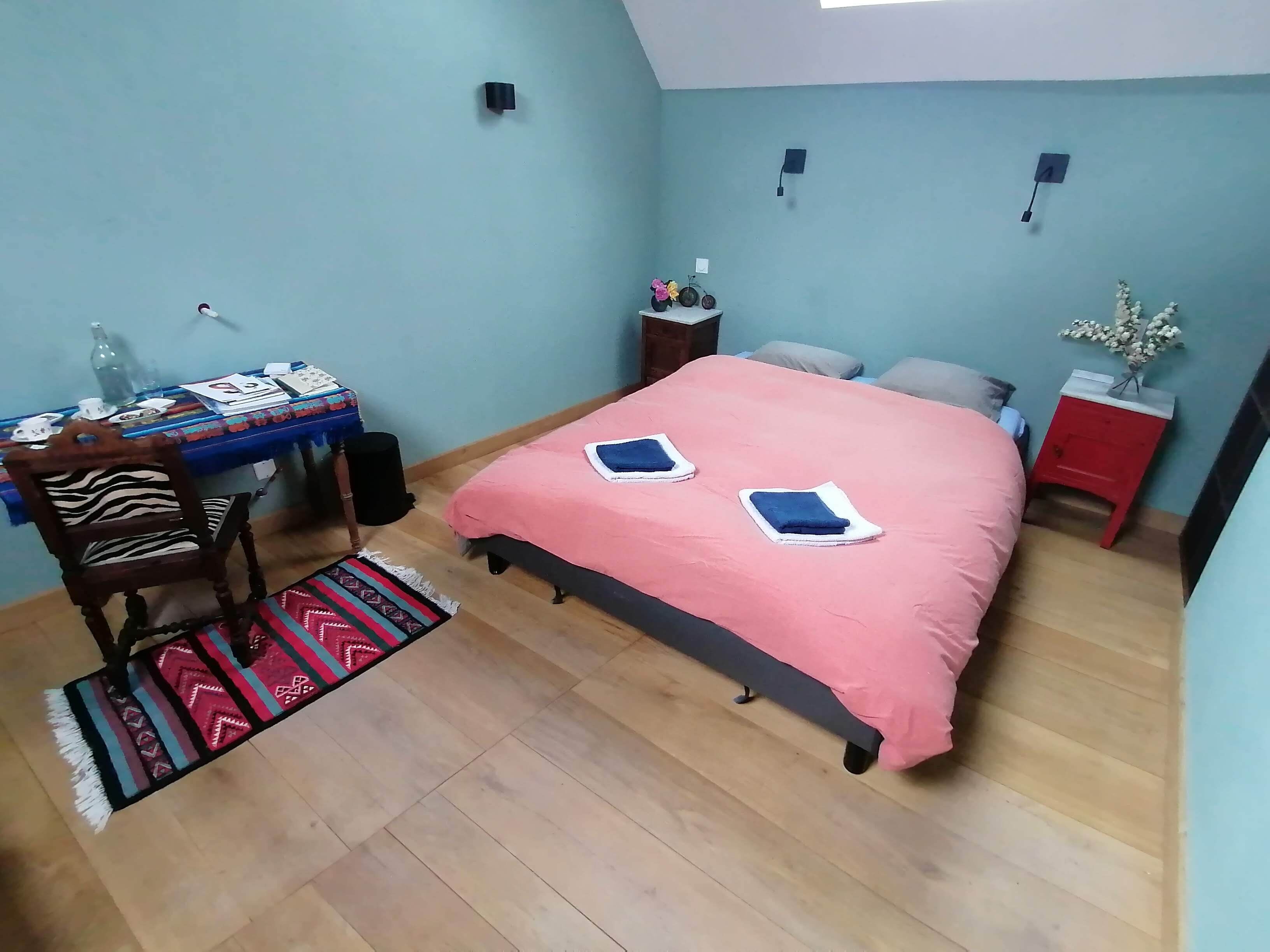 Une chambre à coucher avec un lit, un bureau et une chaise.