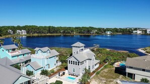 A waterfront property with multiple houses, a dock, and a swimming pool. - Just Peachy - 4 BR/3BA Private Pool (Santa Rosa Beach)