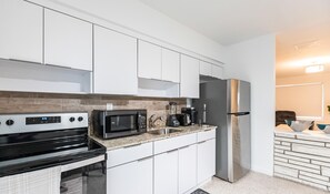 Enjoy cooking in this well-equipped kitchen with a gas stove, microwave, and refrigerator.