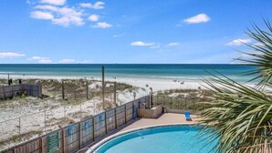 A pool area with a view of the beach and ocean. - Moondrifter #305 2 BR - Free Beach Chairs! (Panama City Beach)
