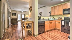 A modern kitchen with wooden cabinets, a dishwasher, and a stove. - Close To It ALL with Indoor & Outdoor Pools (Pigeon Forge)