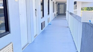 A covered corridor with doors numbered 207, 208, and 209, leading to individual rooms. - Westen Motel (Scooba)