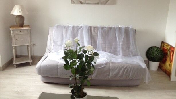 A room with a white sofa, a small table with a lamp, a potted plant, and a framed picture on the wall. - SUPERB GITE IN CORSICAN VILLAGE (Ciamannacce)