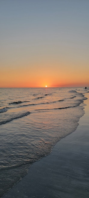 Enjoy a peaceful beach experience with gentle waves lapping against the shore.