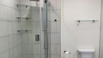 Tina con regadera, toallas, jabón, papel de baño