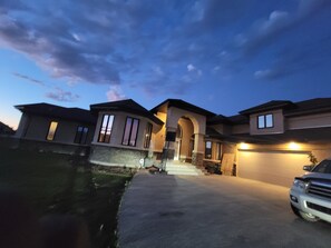 A multi-story house with a driveway and a garage.