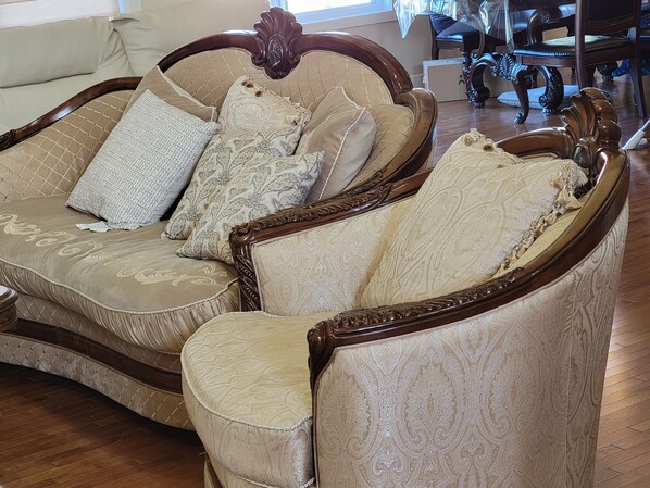 A classic armchair with a cushioned seat and backrest, upholstered in a patterned fabric.