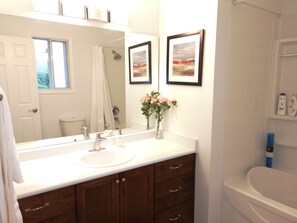 Combined shower/tub, hair dryer, slippers, towels