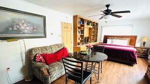 A compact living space with a sofa, a small table, a bed, and a ceiling fan. - Wonderful Home (Pottstown)