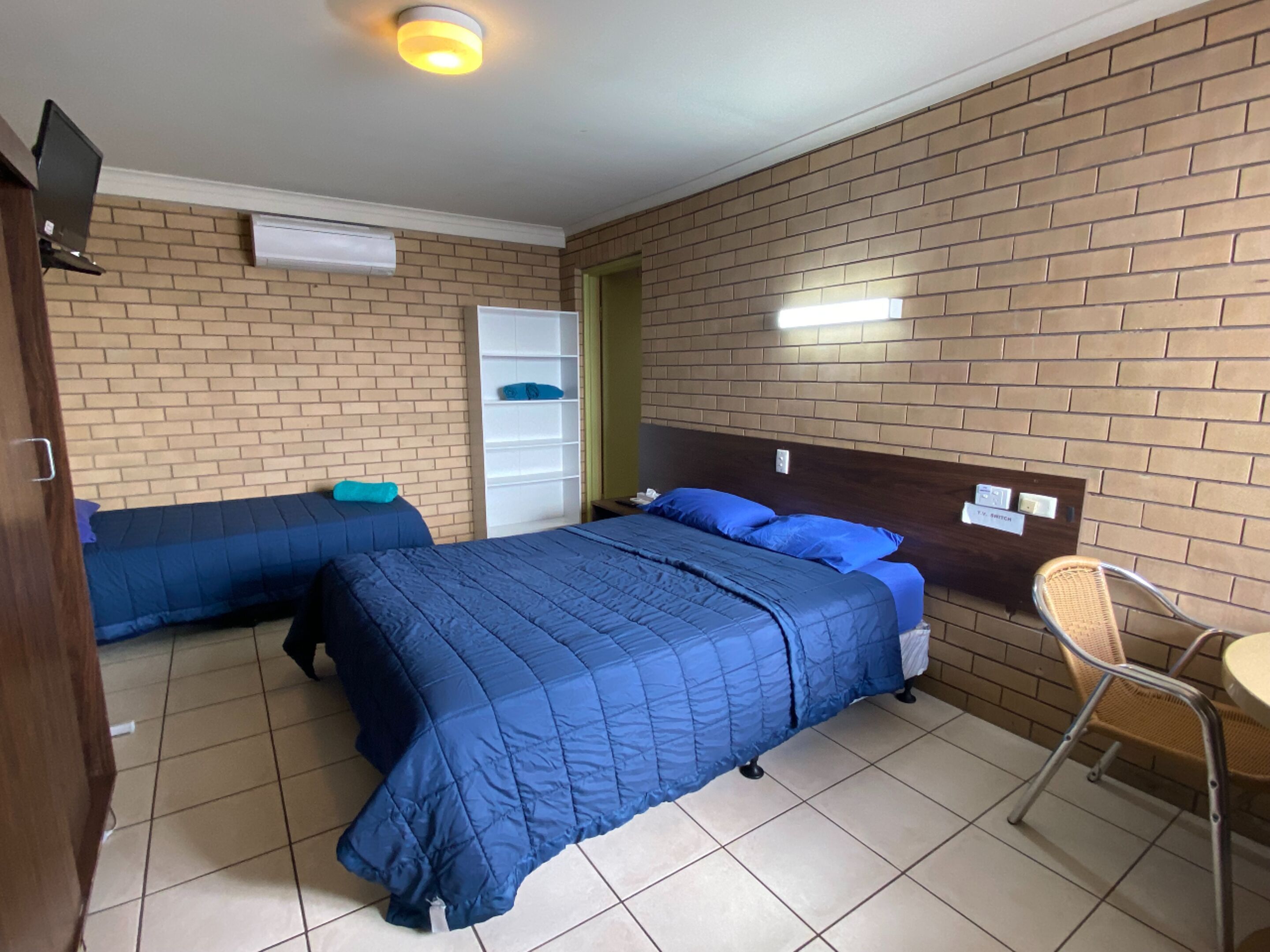 Desk, iron/ironing board, bed sheets