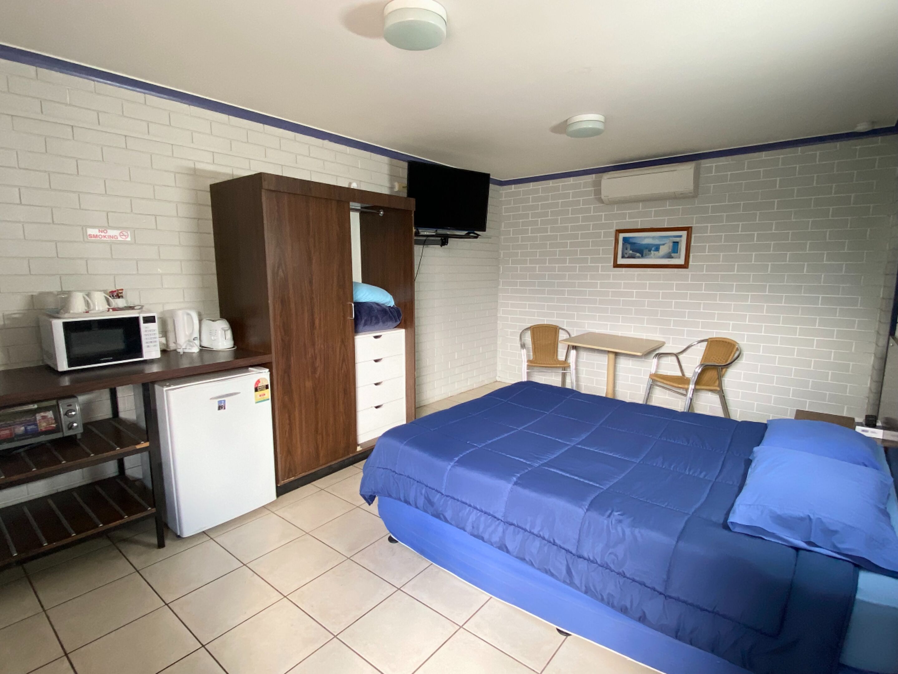 Desk, iron/ironing board, bed sheets