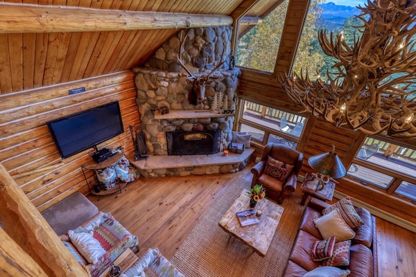 So warm and welcoming. With cathedral ceiling, lustrous wood walls and floors, comfortable custom furnishings, large windows letting in plenty of suns