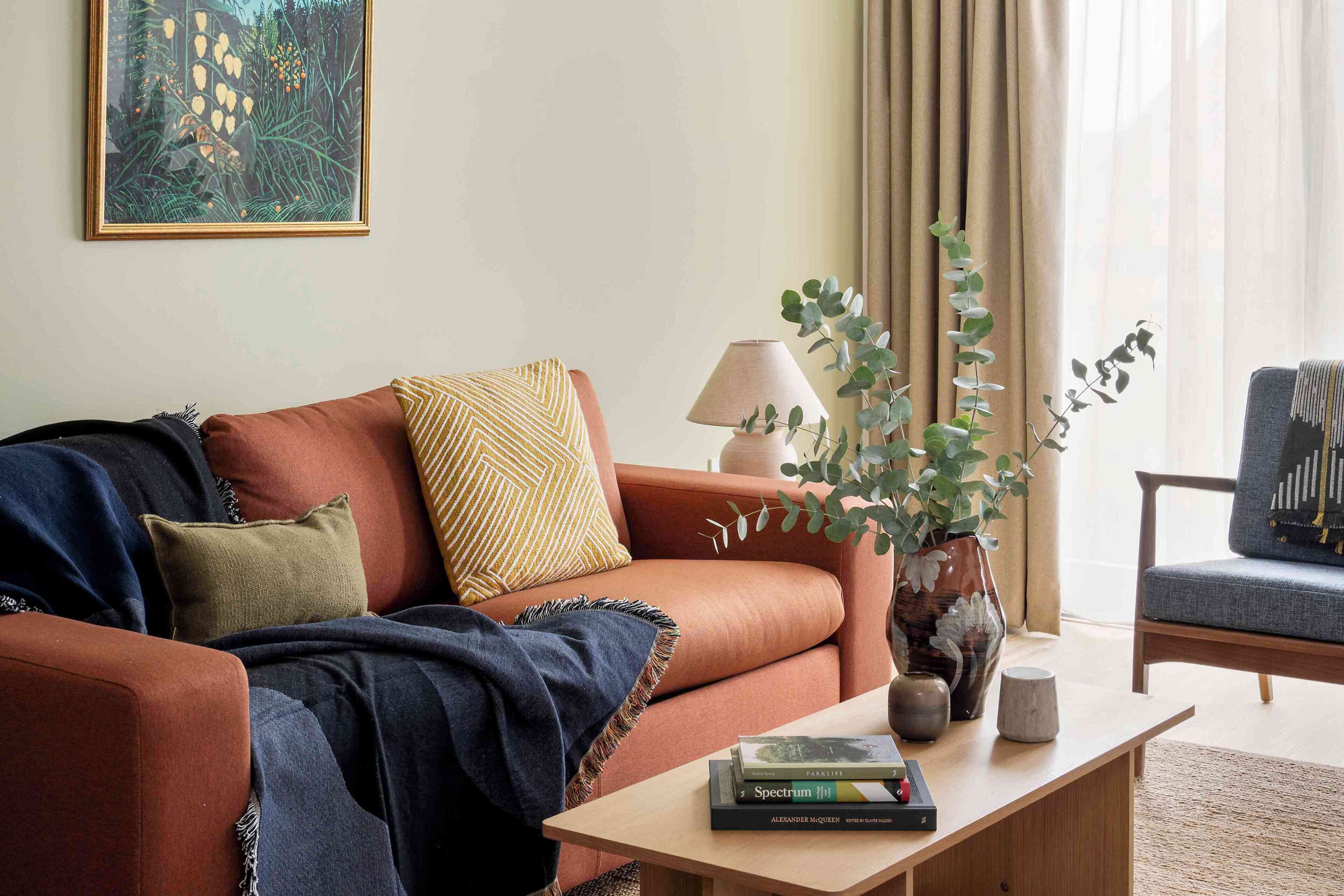A living room with a sofa, a coffee table, and a bookshelf.
